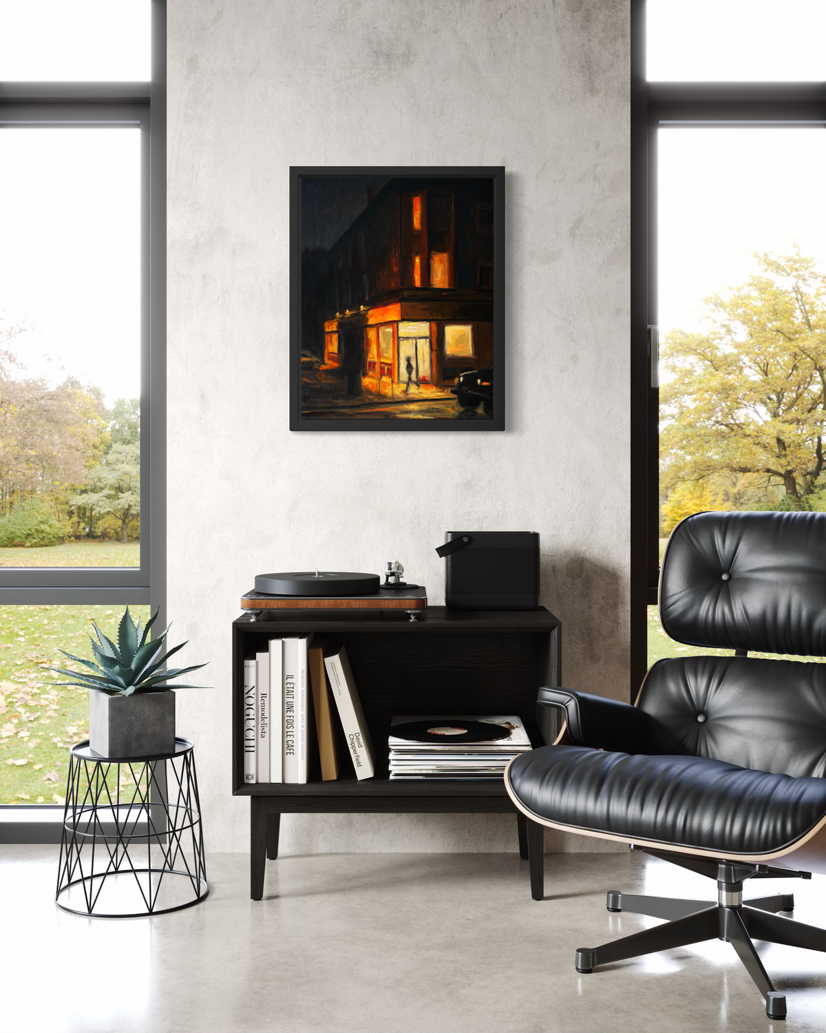 "Corner Store" original oil painting by John Wellington — framed in a modern loft with a black leather lounge chair
