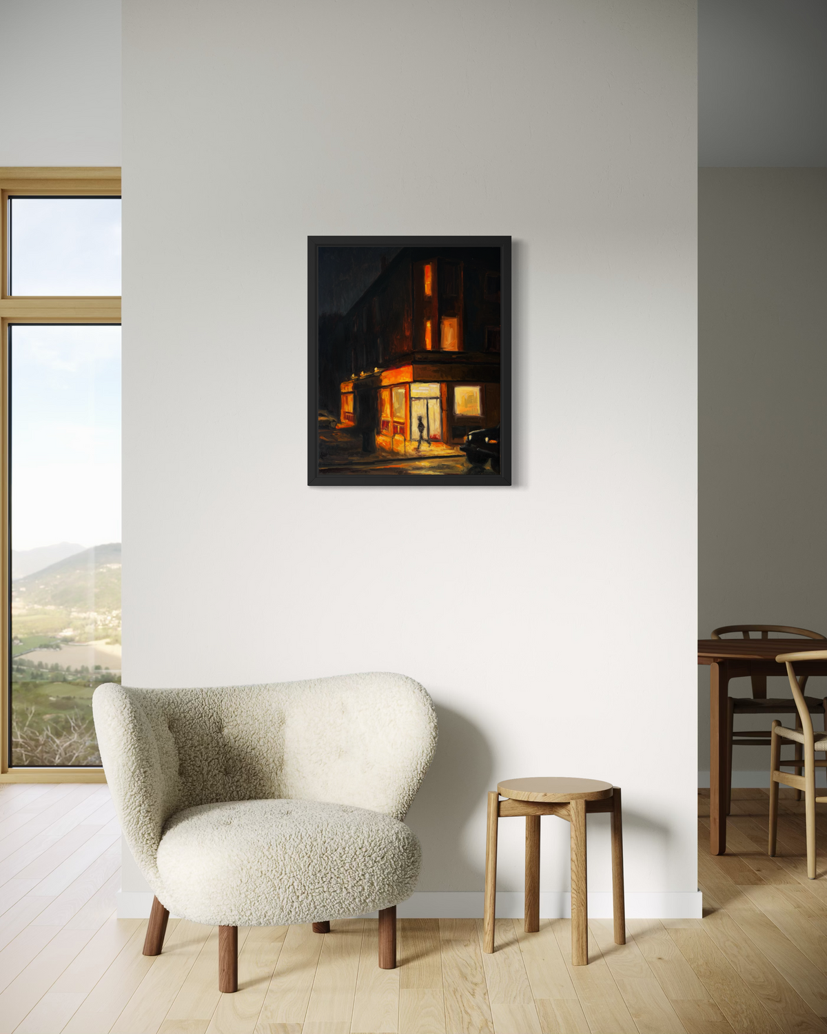 "Corner Store" original oil painting by John Wellington — framed in a bright living room beside a cream bouclé chair