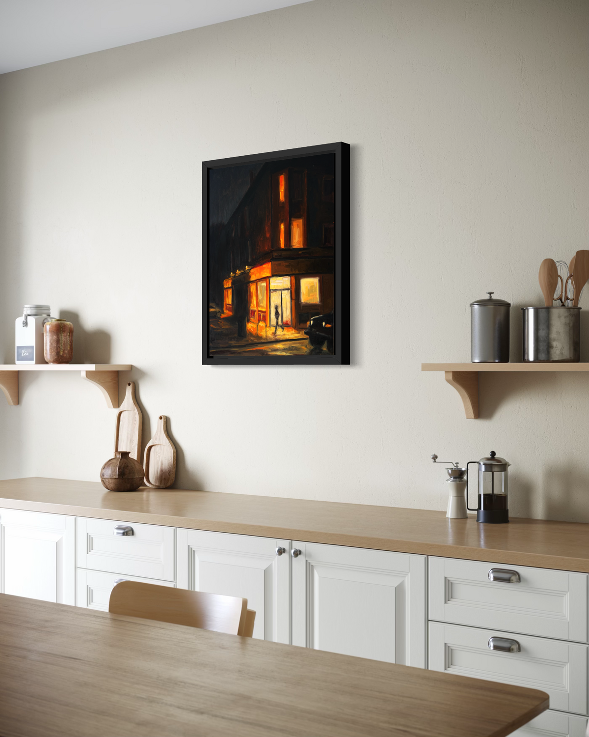 "Corner Store" original oil painting by John Wellington — framed above a white kitchen counter with open shelving