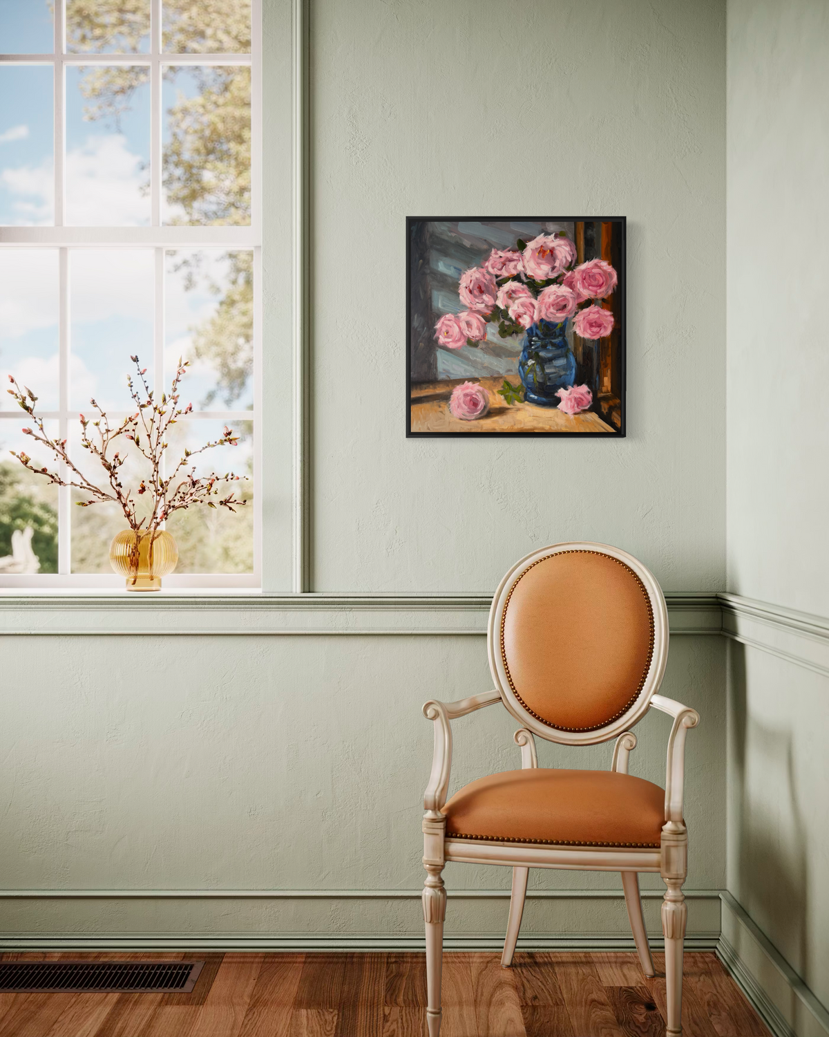 "Pink Roses" original oil painting by John Wellington — framed on a sage green wall beside a sunny window